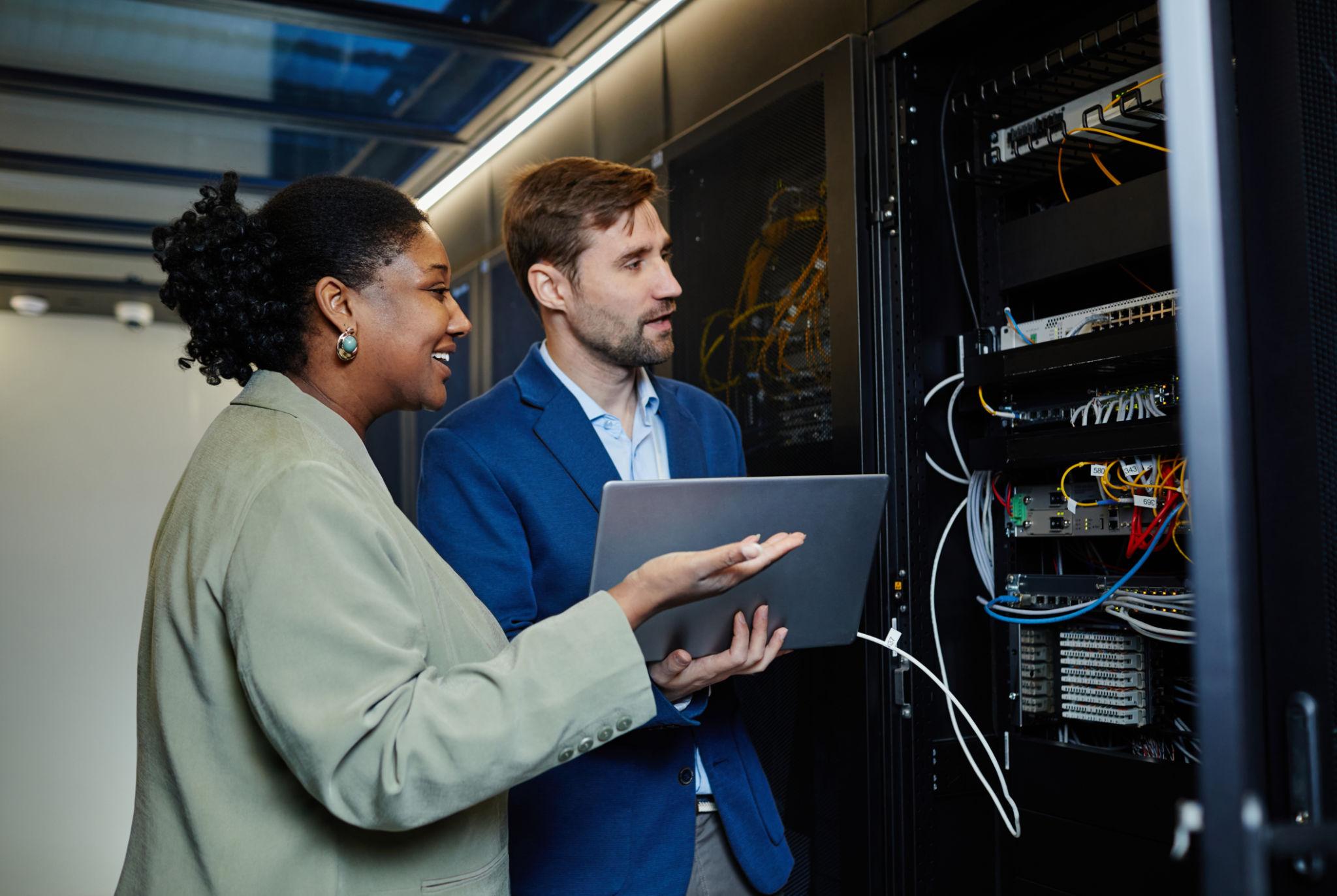 Jantec engineers reviewing a network rack